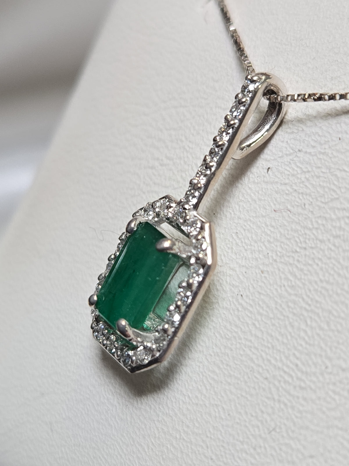 14K white gold pendant featuring a 0.75ct emerald-cut emerald, weighing 1.1g, from Chique Jewelry.
