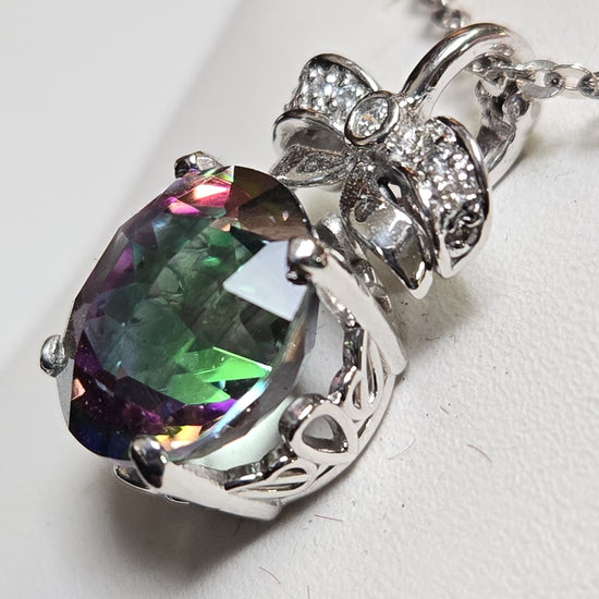 14K white gold pendant featuring a round treated mystic topaz gemstone, weighing 4.5 grams, from Chique Jewelry.