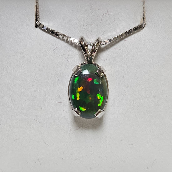 14K white gold oval opal pendant featuring a polished design, weighing 2 grams, by Chique Jewelry.