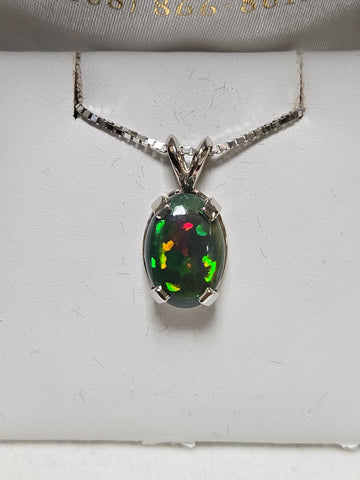 14K white gold oval opal pendant featuring a polished design, weighing 2 grams, by Chique Jewelry.