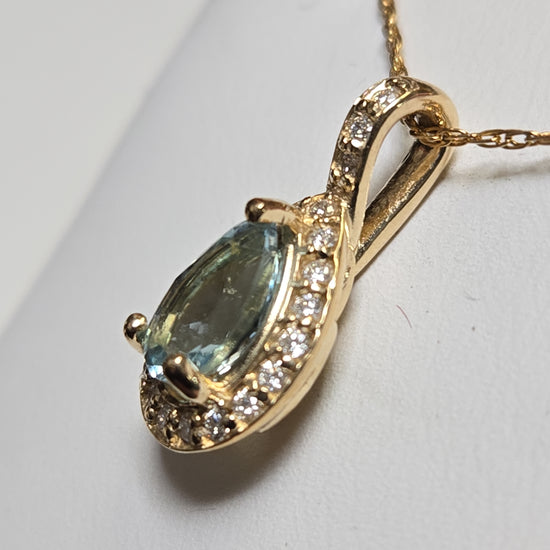 14K gold pendant featuring a 0.78ct pear-shaped aquamarine gemstone, crafted by Chique Jewelry.