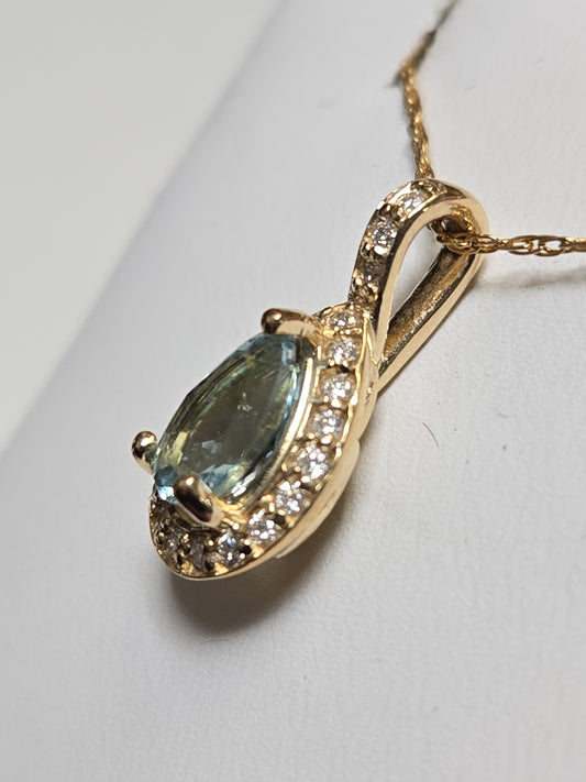 14K gold pendant featuring a 0.78ct pear-shaped aquamarine gemstone, crafted by Chique Jewelry.