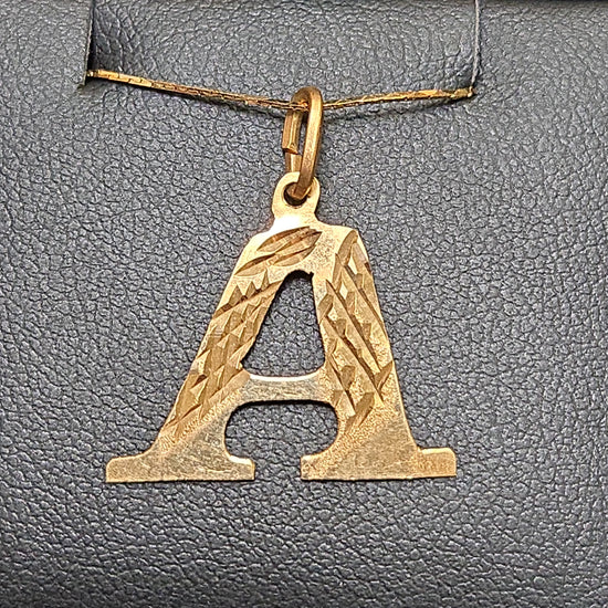 18K gold "A" pendant from Chique Jewelry, 0.8g, featuring a sleek and elegant letter design on a chain.