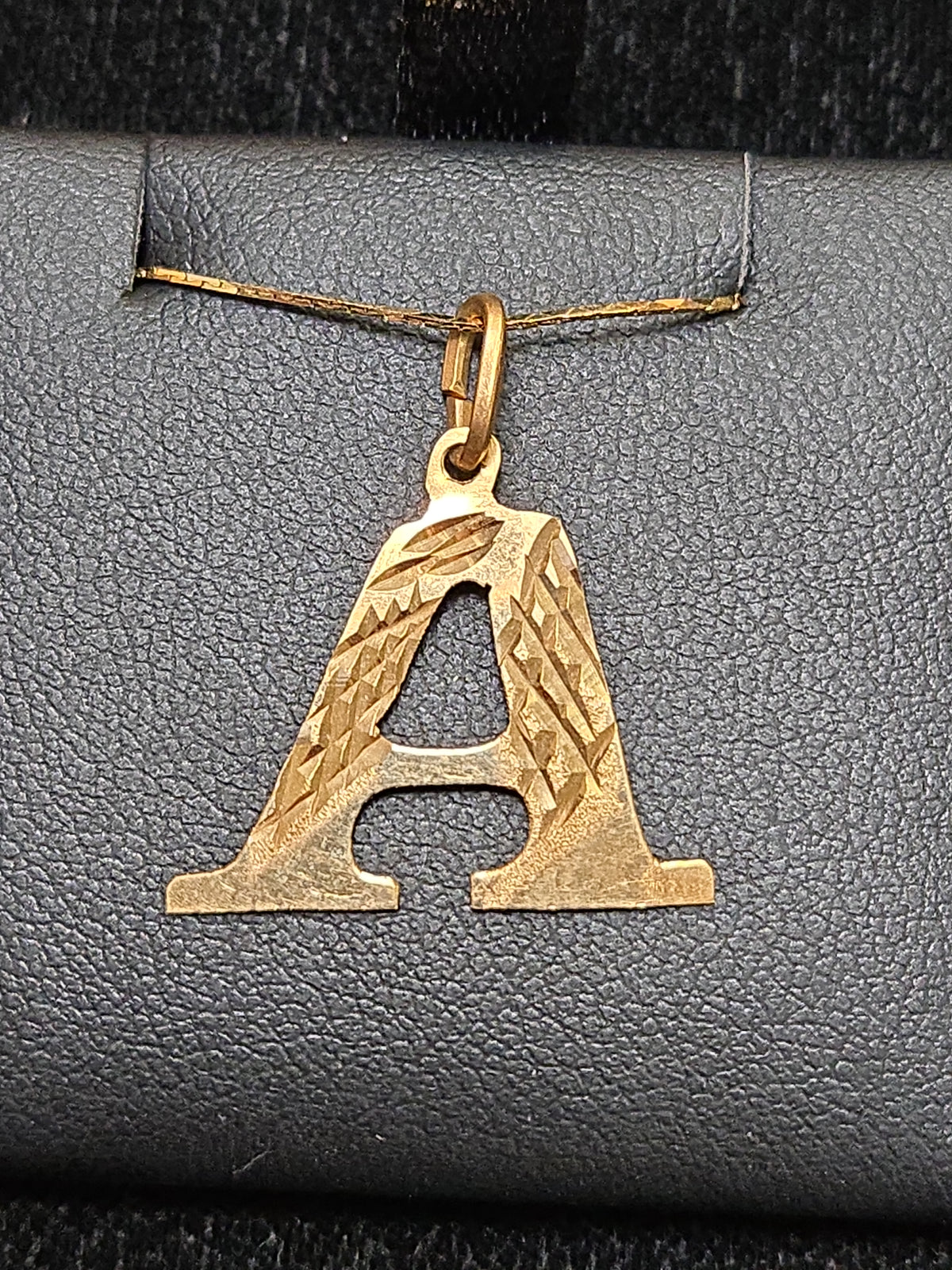18K gold "A" pendant from Chique Jewelry, 0.8g, featuring a sleek and elegant letter design on a chain.