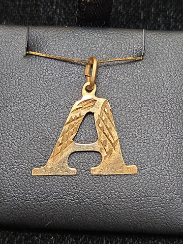 18K gold "A" pendant from Chique Jewelry, 0.8g, featuring a sleek and elegant letter design on a chain.