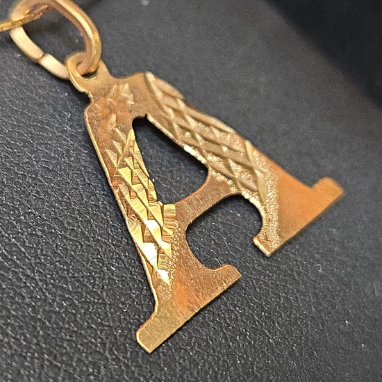 18K gold "A" pendant by Chique Jewelry, sleek gold pendant weighing 0.8g, featuring a stylish letter design.