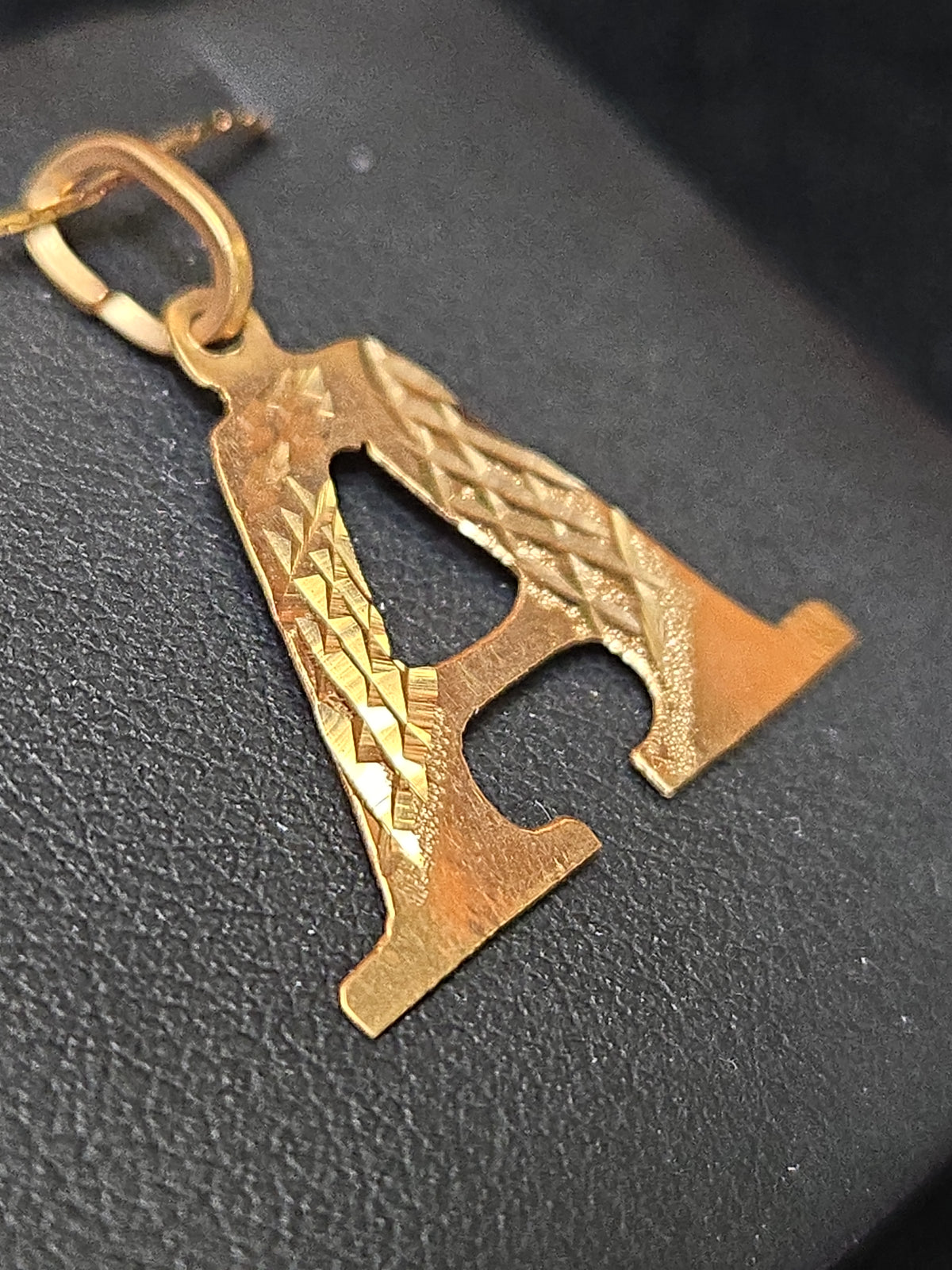 18K gold "A" pendant by Chique Jewelry, sleek gold pendant weighing 0.8g, featuring a stylish letter design.
