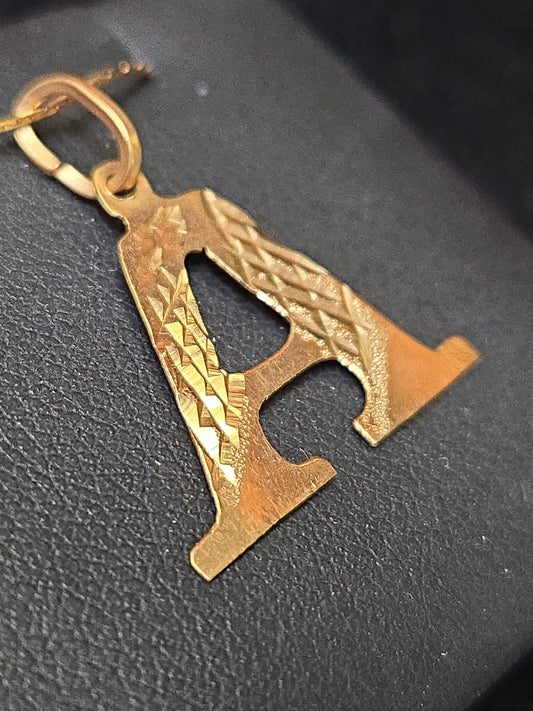 18K gold "A" pendant by Chique Jewelry, sleek gold pendant weighing 0.8g, featuring a stylish letter design.
