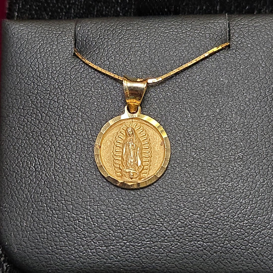 14K gold Mary pendant by Chique Jewelry, featuring a detailed religious figure design, weighs 1.1 grams.