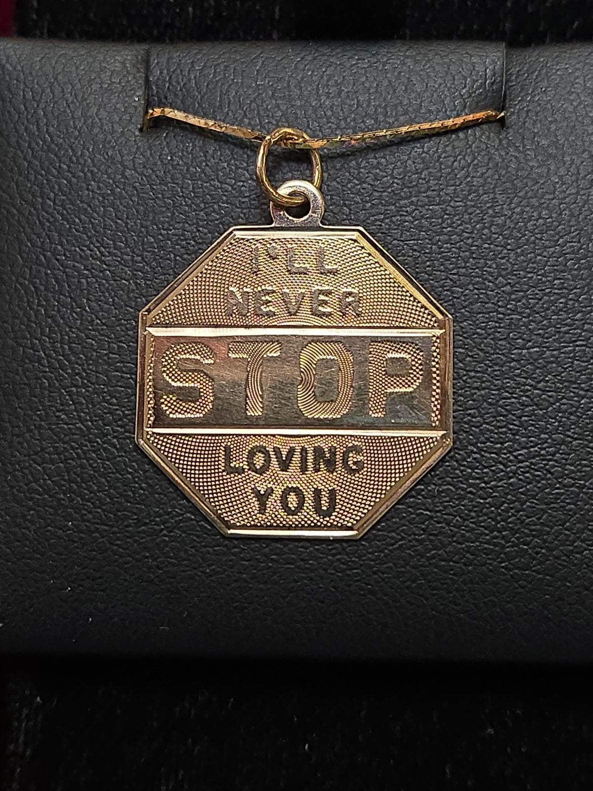14K gold love pendant from Chique Jewelry featuring a heart-shaped design, weighing 1.6 grams.