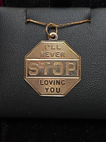 14K gold love pendant from Chique Jewelry featuring a heart-shaped design, weighing 1.6 grams.