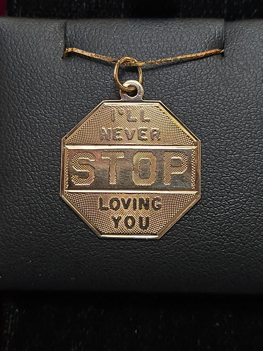 14K gold love pendant from Chique Jewelry featuring a heart-shaped design, weighing 1.6 grams.