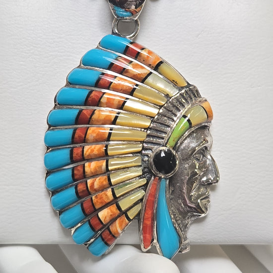 925 Sterling Silver Native American pendant with assorted gemstones, weighing 13.9g, featuring intricate design and vibrant stone details.