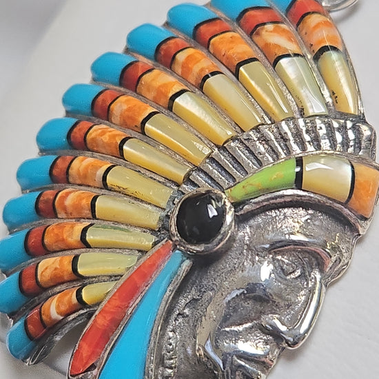 Sterling silver Native American pendant with assorted gemstones, featuring intricate design and vibrant stone details.