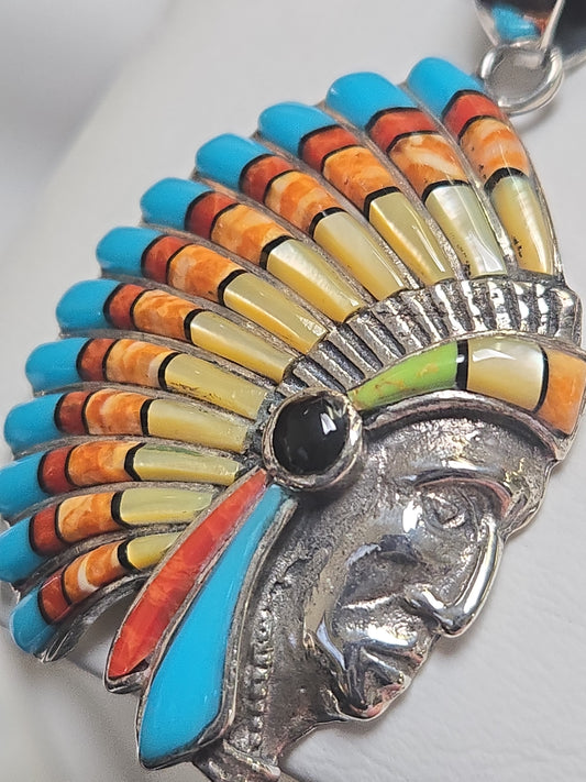 Sterling silver Native American pendant with assorted gemstones, featuring intricate design and vibrant stone details.