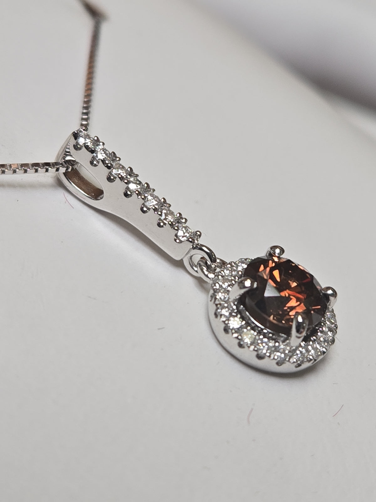 14K white gold pendant featuring a 0.71ct round chocolate diamond, from Chique Jewelry, with a delicate and elegant design.