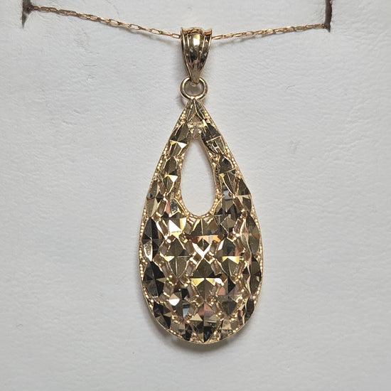 14K gold pendant weighing 2.7 grams from Chique Jewelry with intricate design and polished finish.