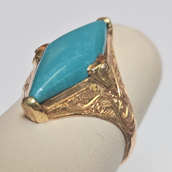 18K gold ring with marquise turquoise gemstone, weighing 4.1g, by Chique Jewelry, featuring elegant design and vibrant blue stone.