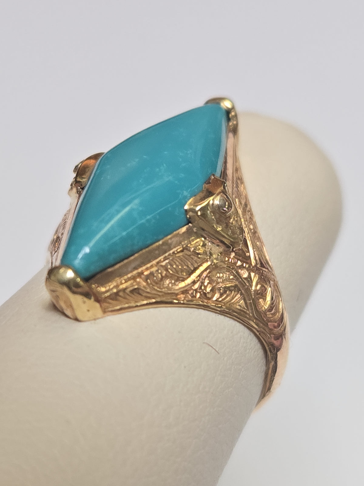 18K gold ring with marquise turquoise gemstone, weighing 4.1g, by Chique Jewelry, featuring elegant design and vibrant blue stone.