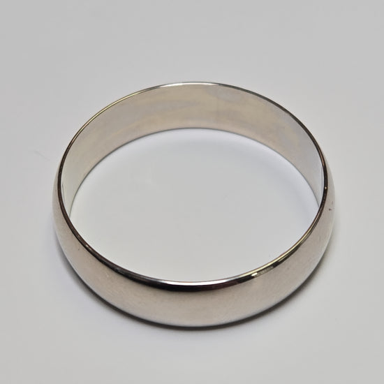 14K white gold ring from Chique Jewelry, showcasing a sleek, polished band with a simple, elegant design.