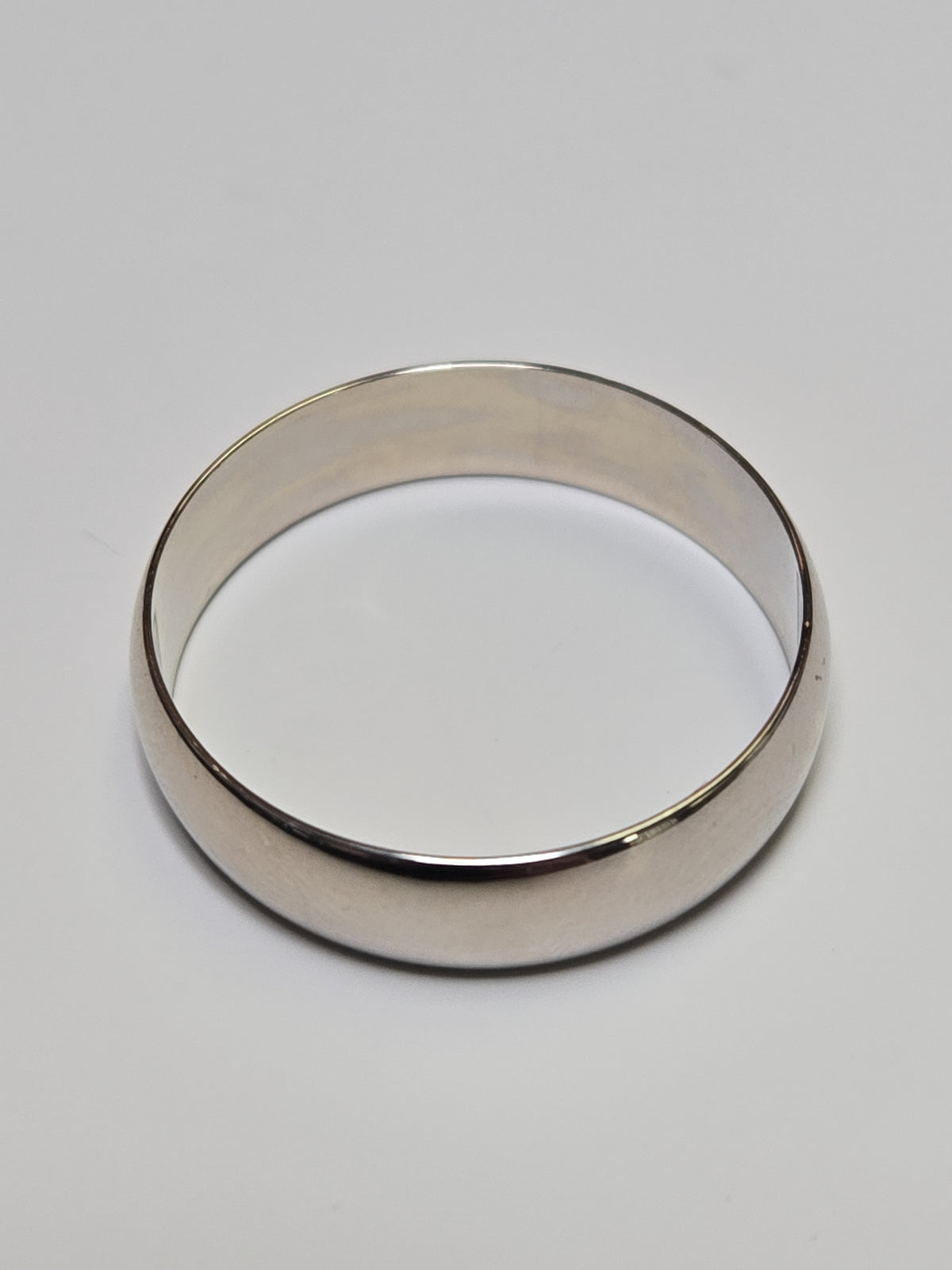 14K white gold ring from Chique Jewelry, showcasing a sleek, polished band with a simple, elegant design.