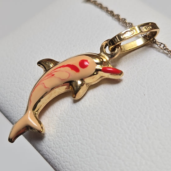 18K gold dolphin pendant from Chique Jewelry, lightweight 0.8g, featuring detailed dolphin design on a chain.