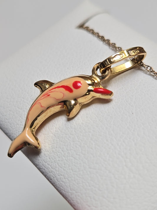 18K gold dolphin pendant from Chique Jewelry, lightweight 0.8g, featuring detailed dolphin design on a chain.
