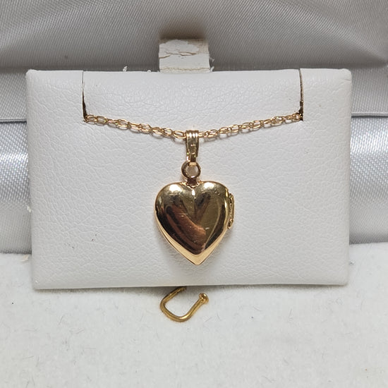 14K gold heart locket pendant from Chique Jewelry, 1g, featuring a delicate design and polished finish.