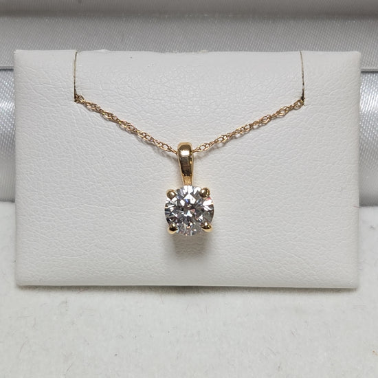 14K gold pendant with round simulated Lannyte diamond, weighing 0.7g, by Chique Jewelry, displayed on a neutral background.