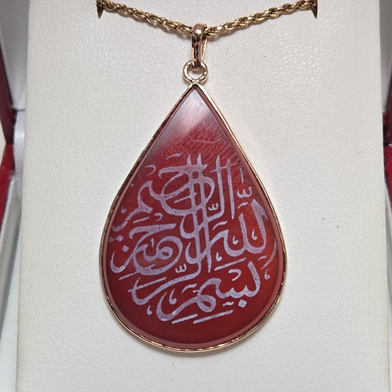 18K gold Islamic passage pendant with pear-shaped carnelian gemstone, weighing 5.1g, from Chique Jewelry.