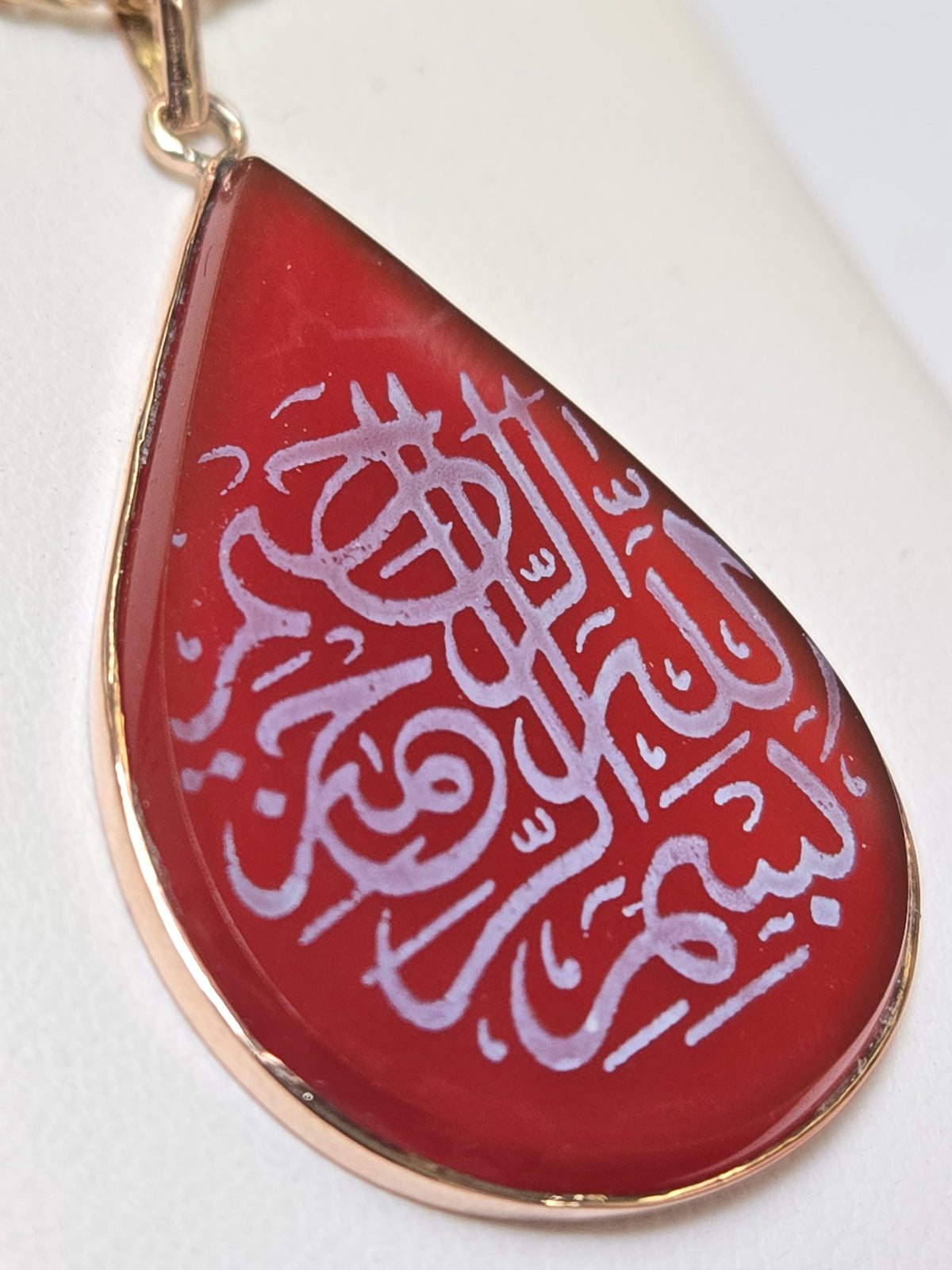 Pear-shaped Carnelian Islamic passage pendant in 18K gold, weighing 5.1g, from Chique Jewelry.