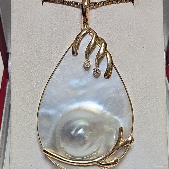 14K gold pendant with a Mabe blister pearl, showcasing elegant jewelry design on a white background.