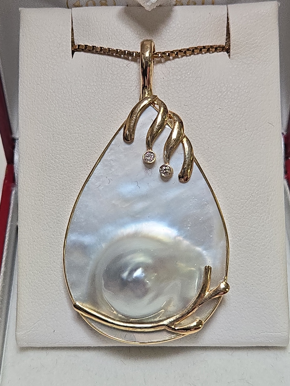14K gold pendant with a Mabe blister pearl, showcasing elegant jewelry design on a white background.