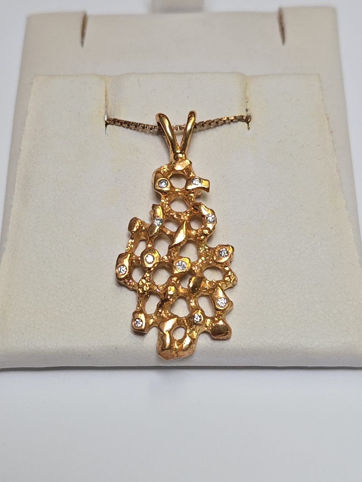 14K gold pendant with 0.11ct round diamond, crafted by Chique Jewelry, featuring a delicate and elegant design.