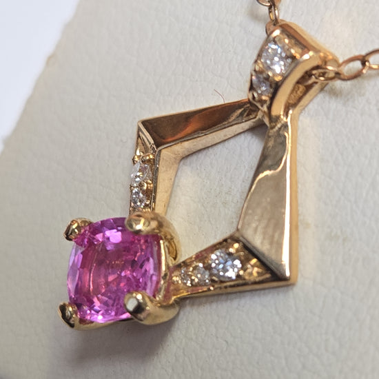 14K gold pendant featuring a 1.3ct cushion-cut pink sapphire, weighing 2.4g, from Chique Jewelry.