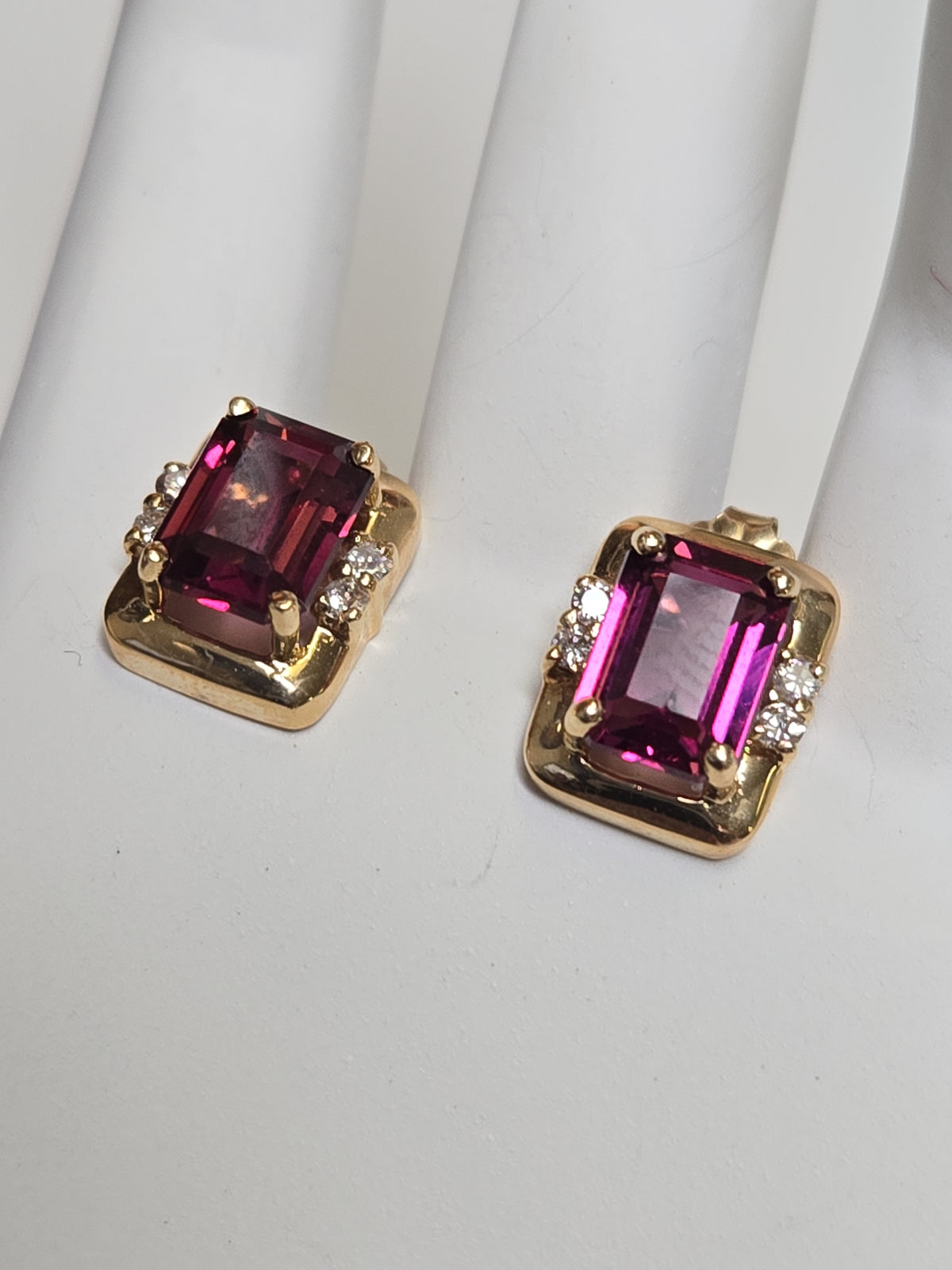 14K gold pendant featuring an emerald-cut rubelite gemstone, crafted by Chique Jewelry, weighing 3.5 grams.