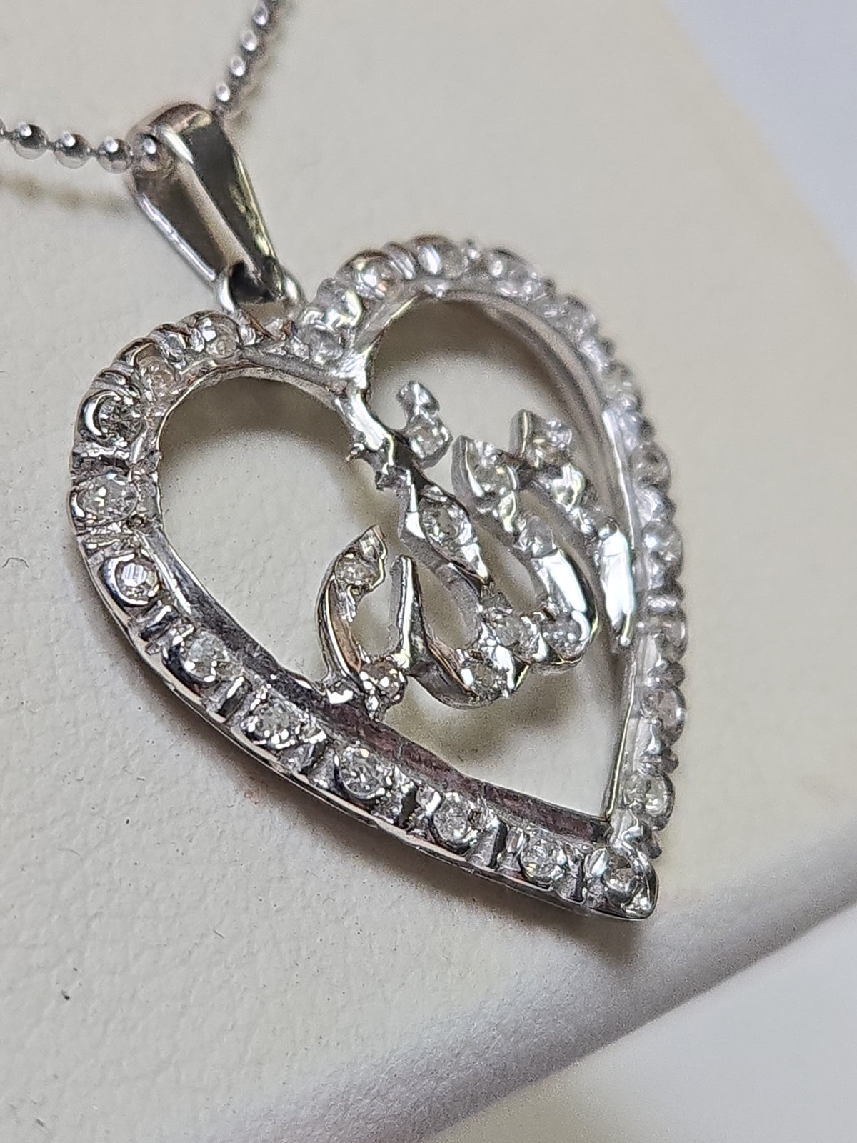 18K white gold Allah pendant with round diamonds, elegant jewelry piece weighing 2 grams, designed by Chique Jewelry.