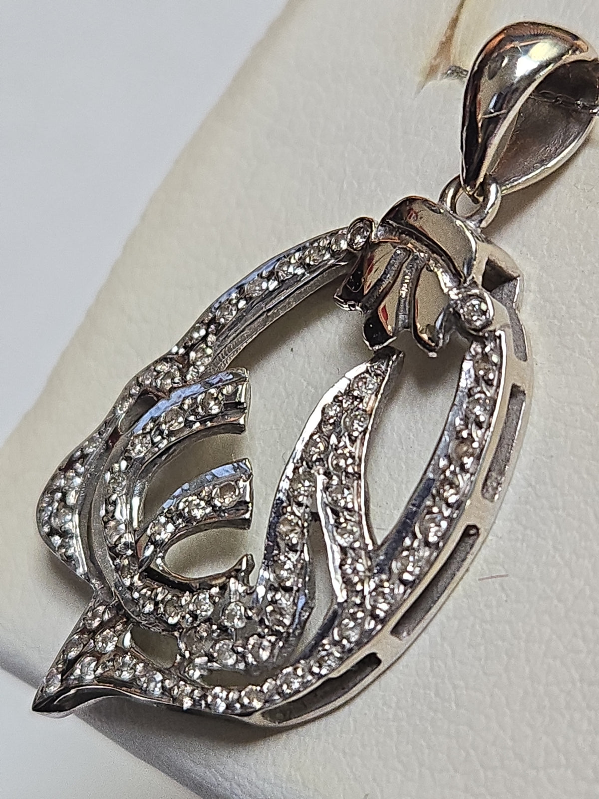 18K white gold Allah pendant with round diamonds, elegant jewelry piece by Chique Jewelry, showcasing intricate design and sparkling stones.