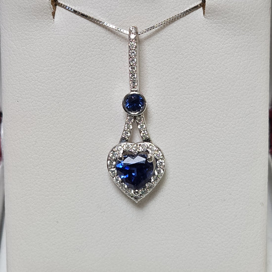 14K white gold heart-shaped pendant with 1.5ct simulated blue sapphire, crafted by Chique Jewelry.