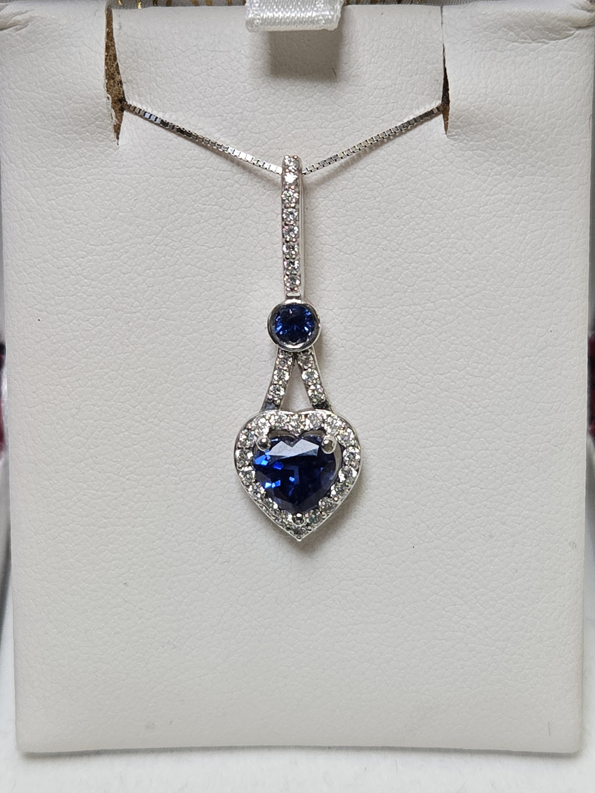 14K white gold heart-shaped pendant with 1.5ct simulated blue sapphire, crafted by Chique Jewelry.