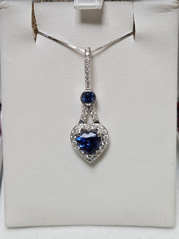 14K white gold heart-shaped pendant with 1.5ct simulated blue sapphire, crafted by Chique Jewelry.