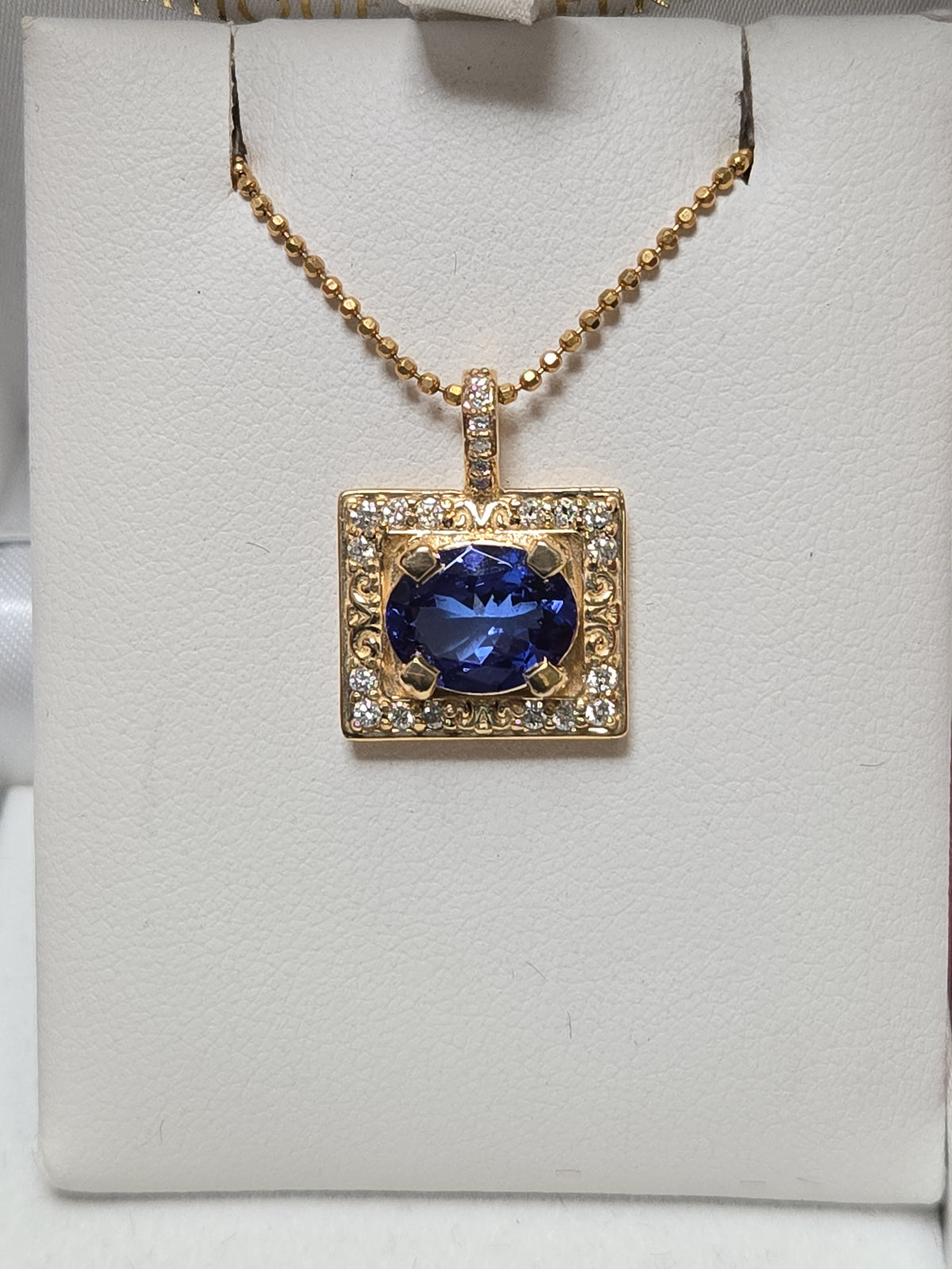 14K gold pendant featuring a 2.44ct oval Tanzanite gemstone, designed by Chique Jewelry, with a sleek and elegant style.