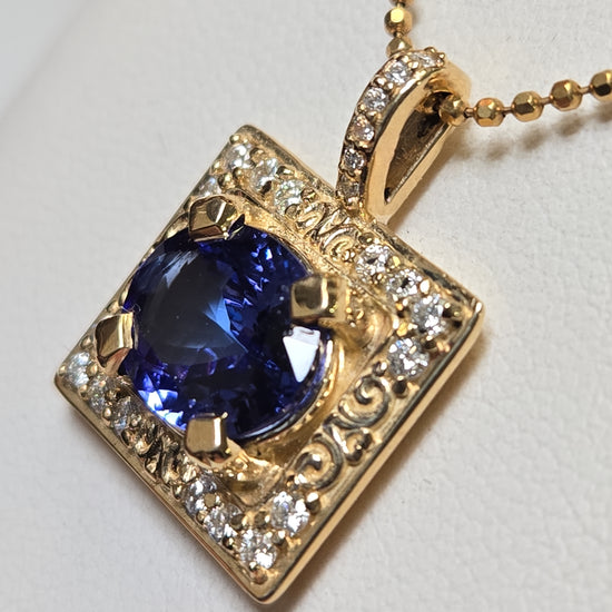 14K gold pendant with 2.44ct oval Tanzanite gemstone, featuring a elegant design, by Chique Jewelry.