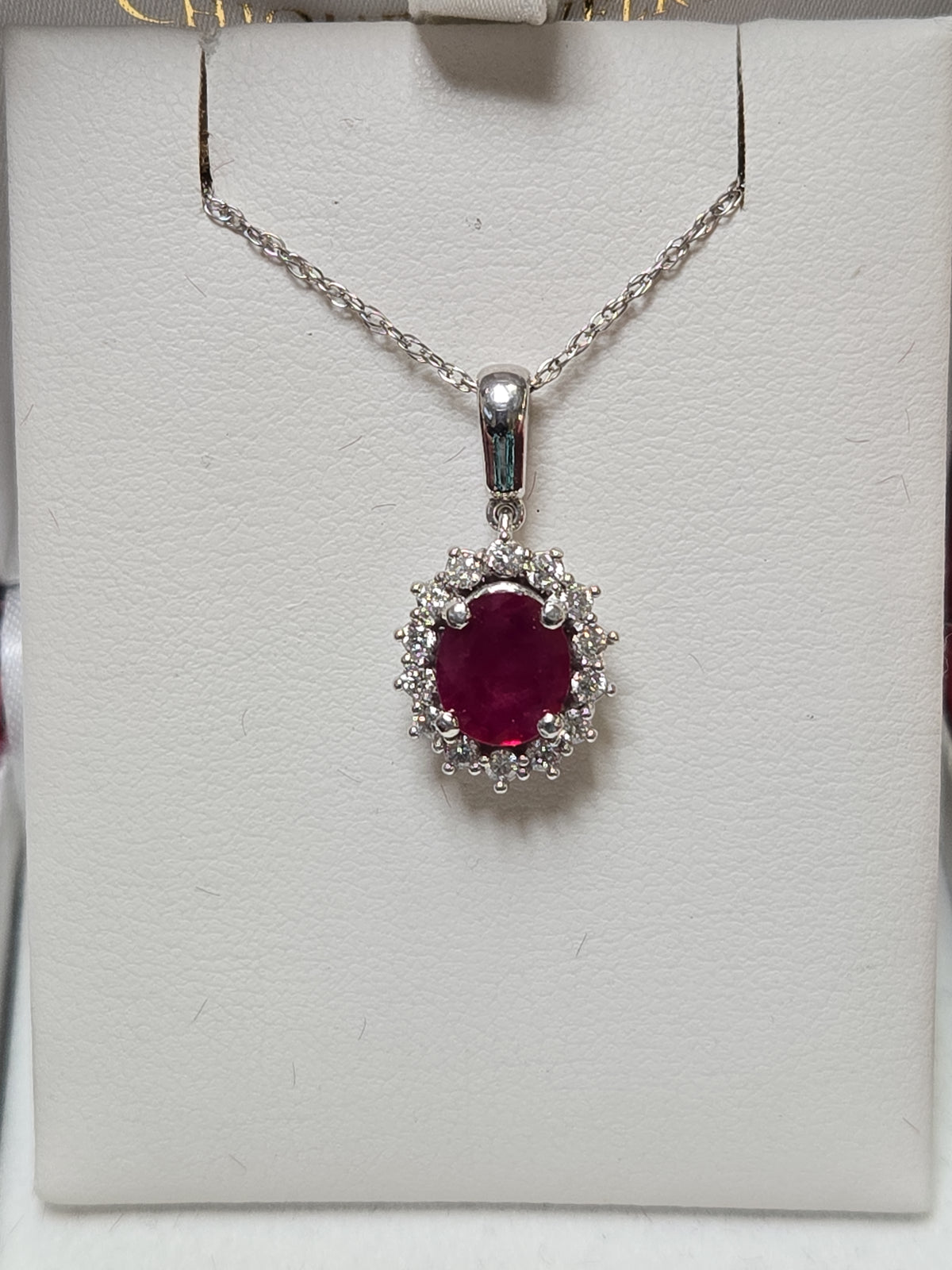 14K white gold pendant featuring a 1.5ct oval ruby, weighing 2.7g, from Chique Jewelry.