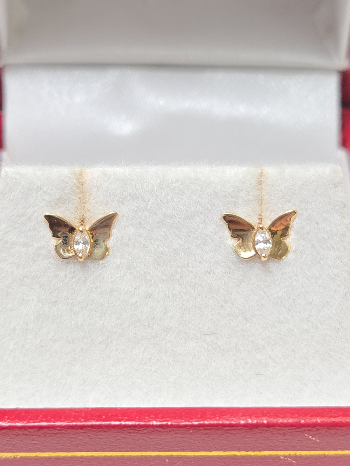 14K gold stud earrings with round cubic zirconia stones, featuring a simple and elegant design by Chique Jewelry.