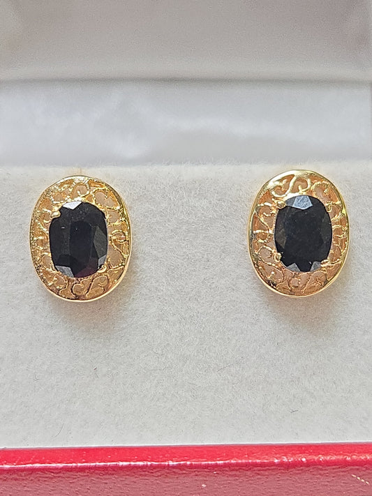 14K gold filigree stud earrings with 1.5ct oval sapphire, elegant jewelry by Chique Jewelry, showcasing intricate design and sparkling gemstone.