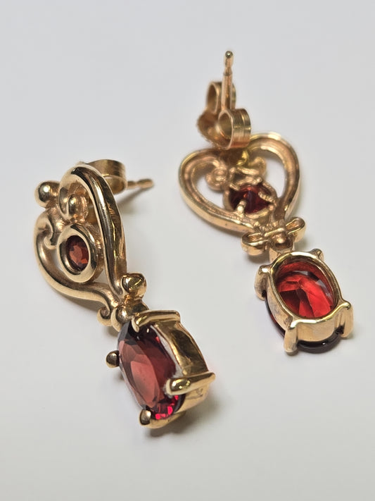 14K gold drop earrings with 2ct oval garnets and 3.4g weight, featuring elegant jewelry design.