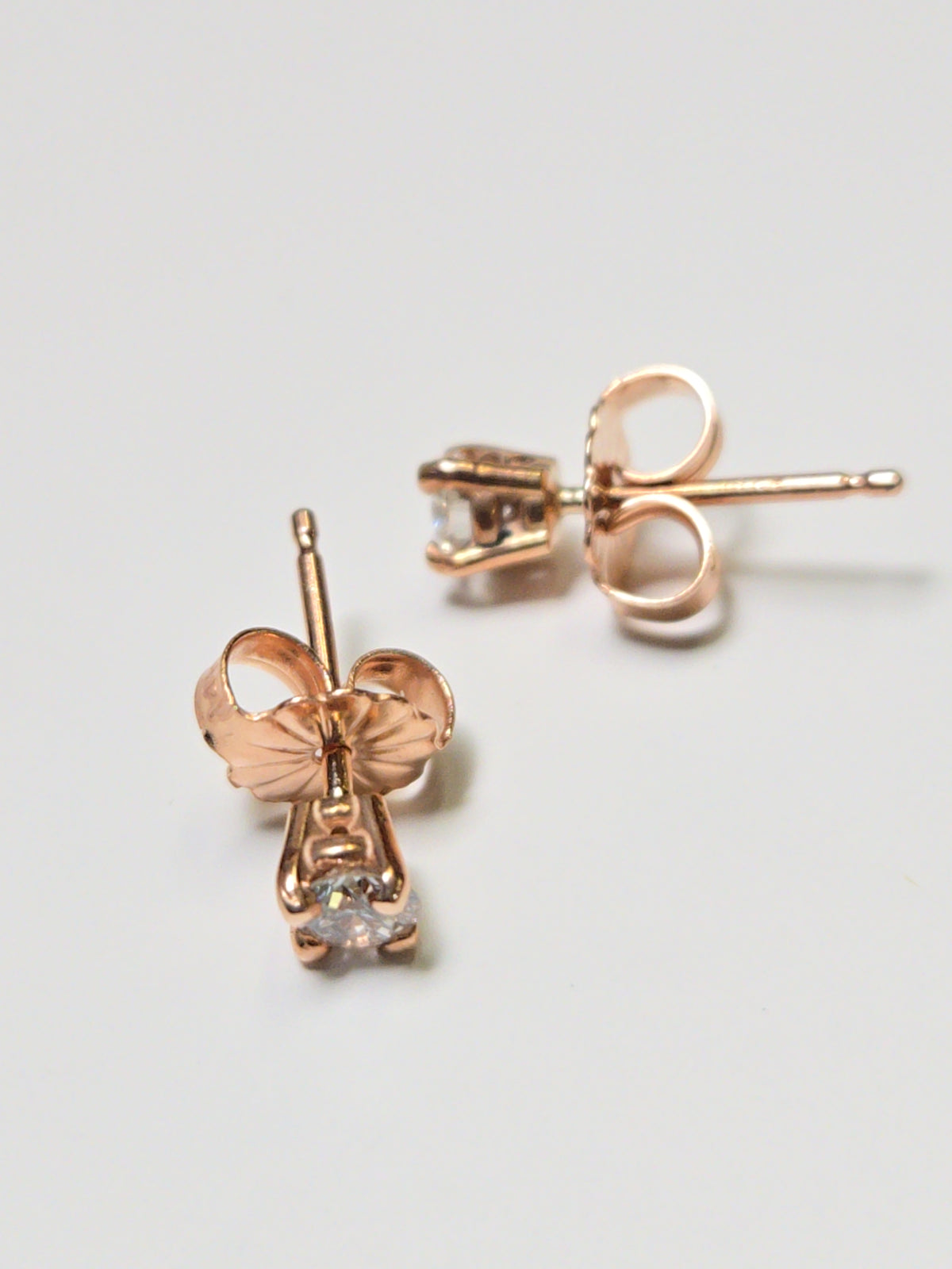 14K rose gold stud earrings with 0.26ct round diamonds from Chique Jewelry, featuring a sleek and elegant design.