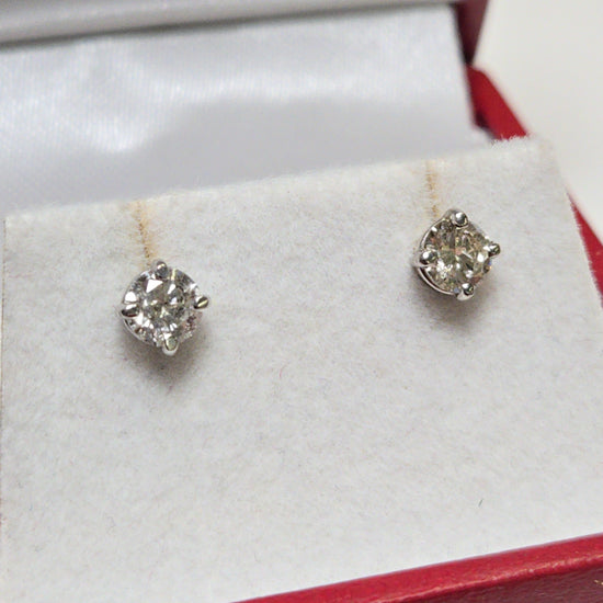 14K white gold stud earrings with 0.66ct round diamonds, featuring a sleek design and elegant sparkle from Chique Jewelry.