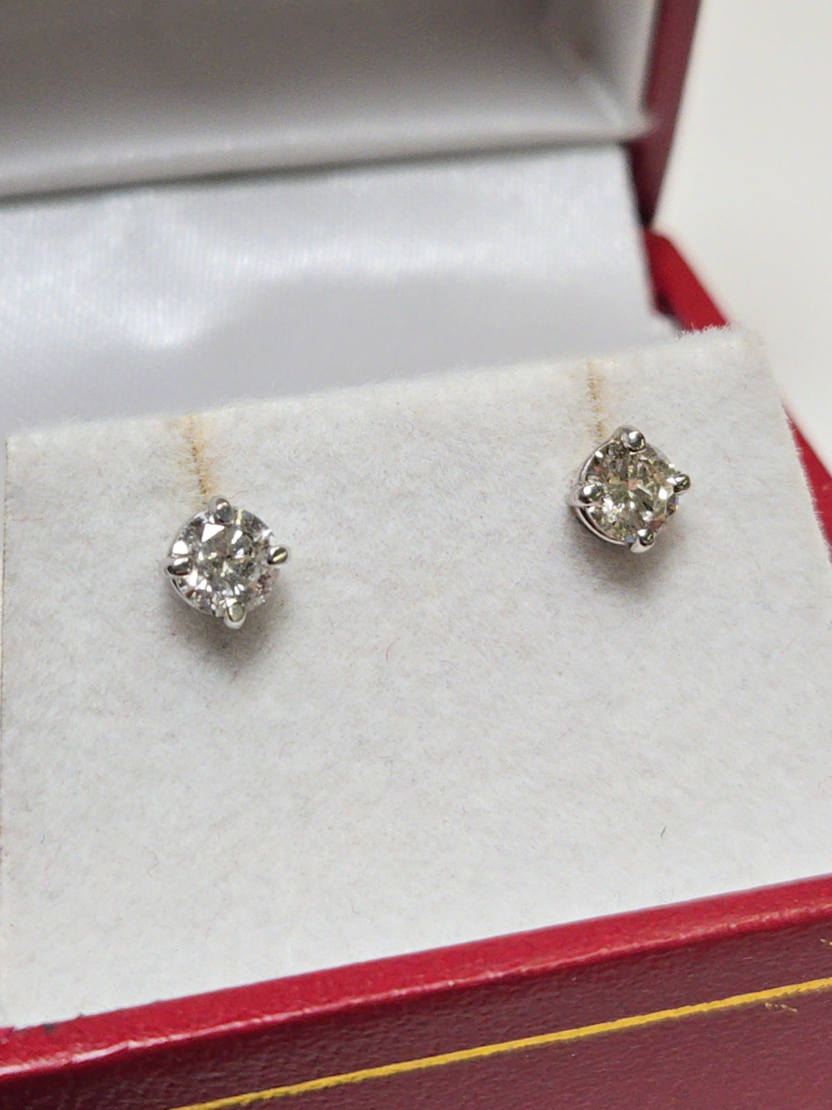14K white gold stud earrings with 0.66ct round diamonds, featuring a sleek design and elegant sparkle from Chique Jewelry.